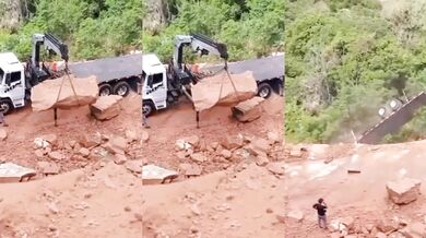 Odstraňování obřího kamene ze silnice